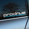Plotrovaná nálepka na auto s logom Prodrive, biely futuristický nápis s modrou spodnou líniou v celkovo dynamickom štýle.