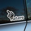 Plotrovaná nálepka na auto s nápisom „Haters“ a rukou so vztýčeným prostredníkom, provokatívny dizajn pre rebelov.