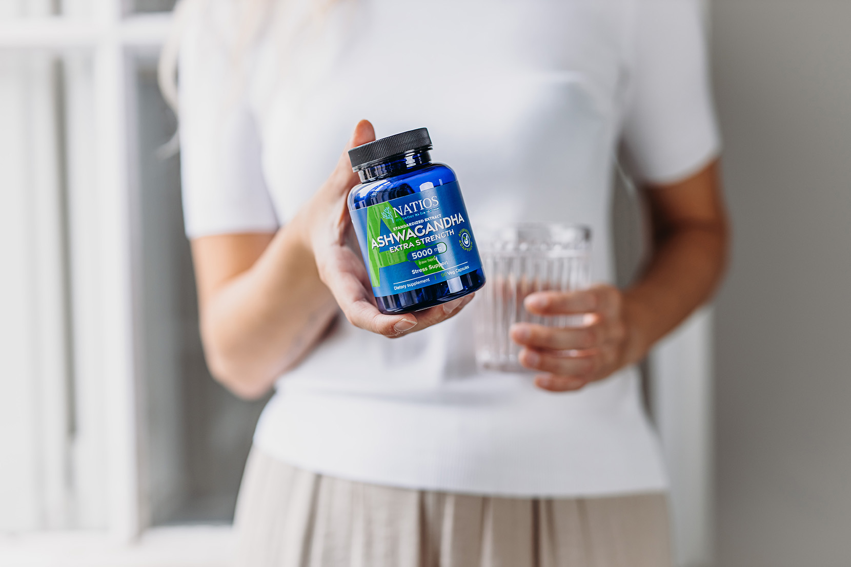 Kobieta-trzyma-buteleczkę-natios-ashwagandha