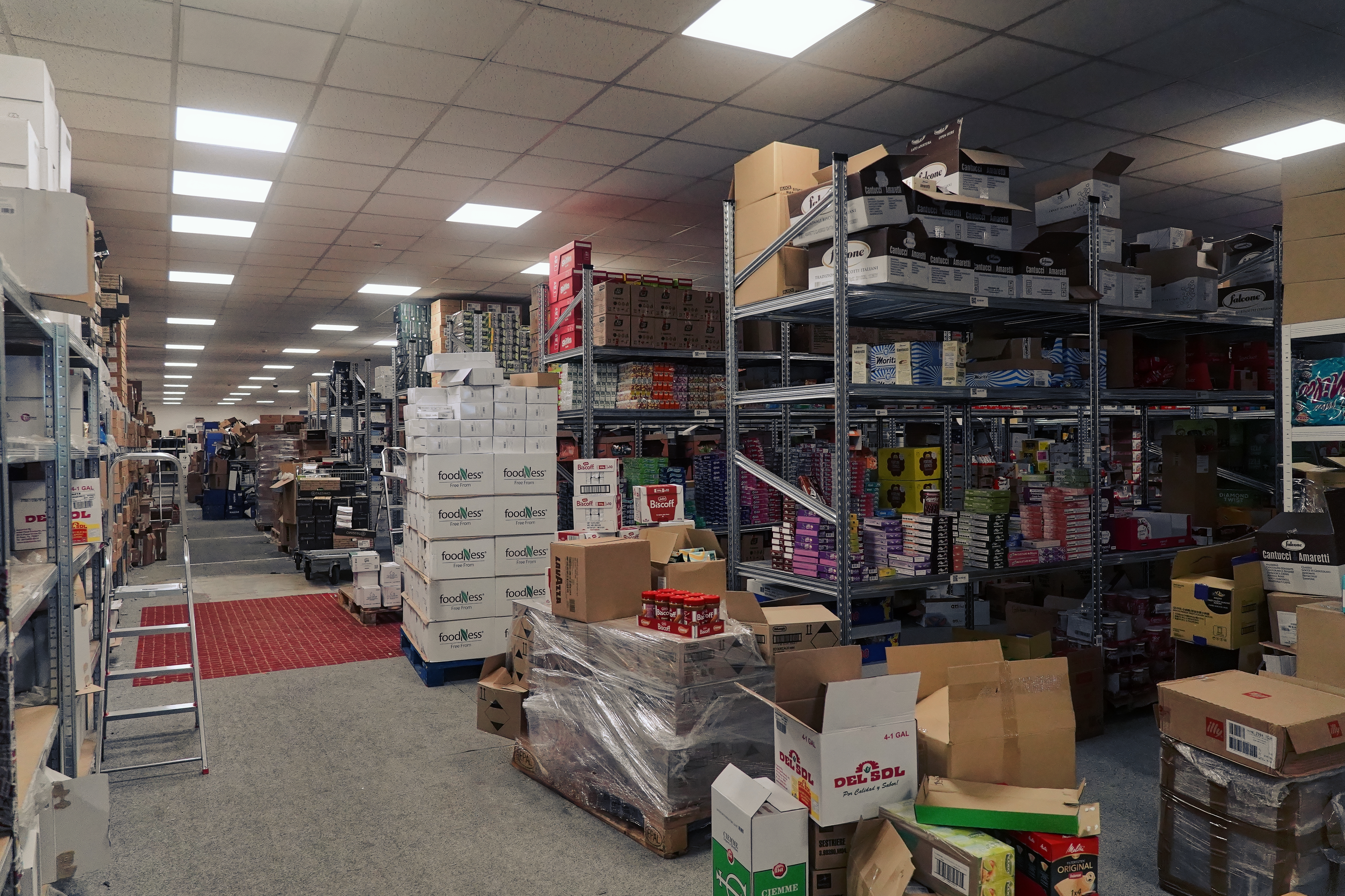 Wide view of the Nejkafe warehouse with shelves full of coffee and sweets
