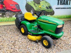 zahradni traktor john deere zelene barvy s velkymi koly pred plachtou traktory