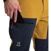 Pánské softshellové kalhoty Haglofs Roc Sight - žlutá/tm.modrá (Velikost 48)