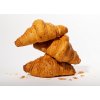 three stacked fresh croissants french bakery sweet dough dessert composition with crumbs