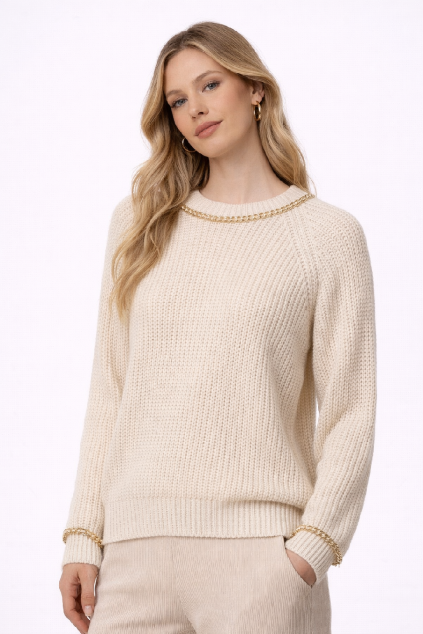 Model in cream sweater with gold accents