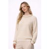 Model in cream sweater with gold accents