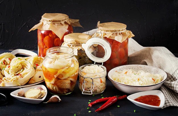 cabbage-kimchi-tomatoes-marinated-sauerkraut-sour-glass-jars-rustic-kitchen-table_2829-18677-freepik