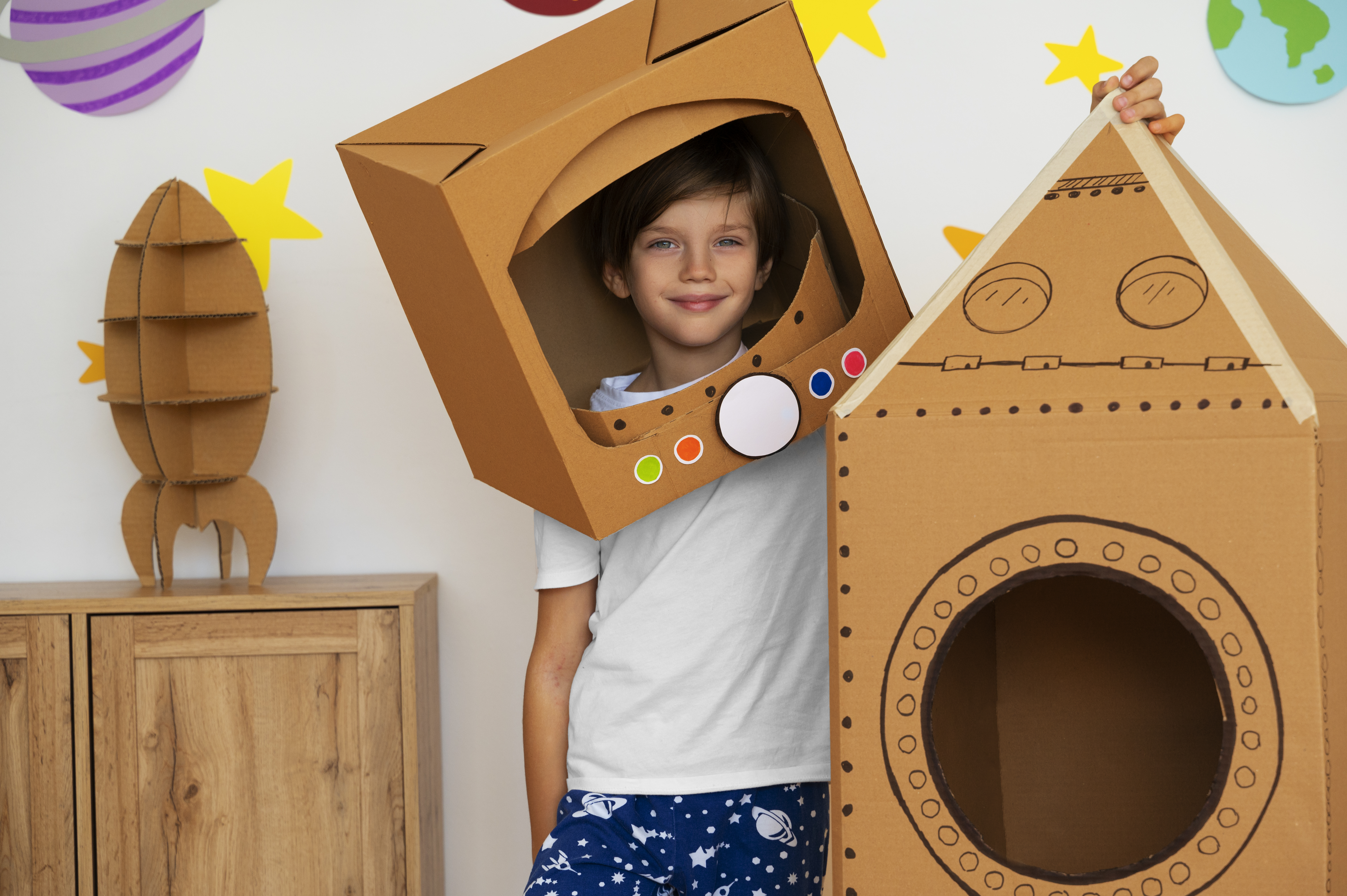 smiley-kid-with-cardboard-rocket-front-view