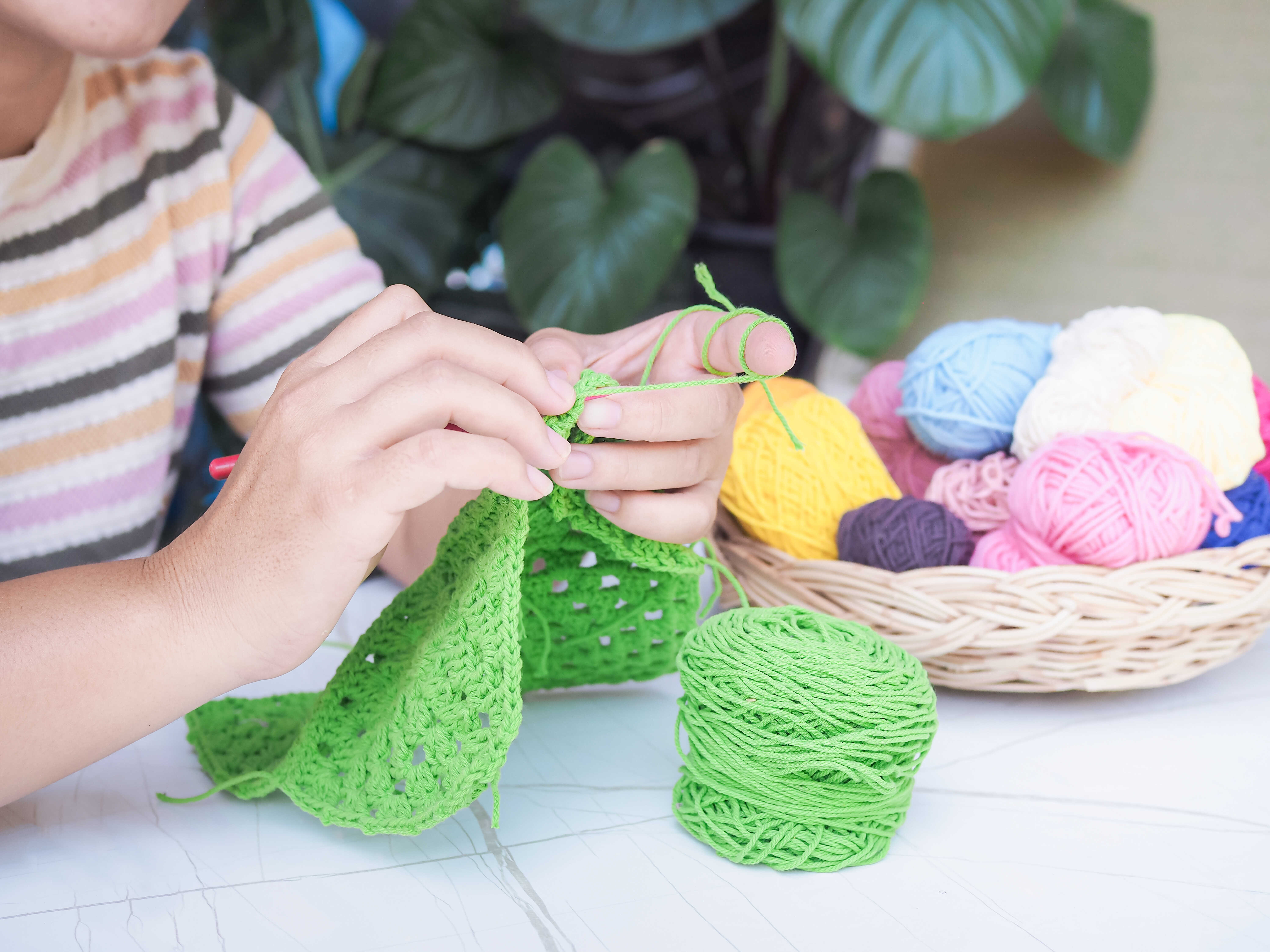 vecteezy_close-up-of-woman-hand-knitting-with-green-wool_39951629_optimized