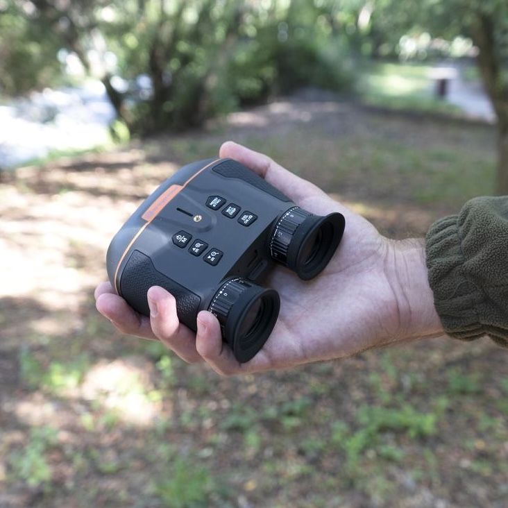 Ork Hunter NIGHT HB-4 held flat in the hand, showing the dual lens and top controls