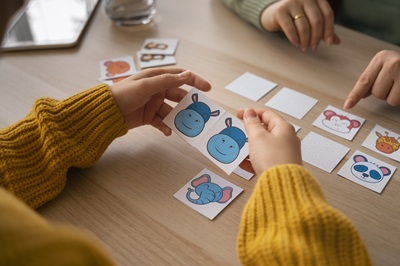 high-angle-kid-playing-memory-game