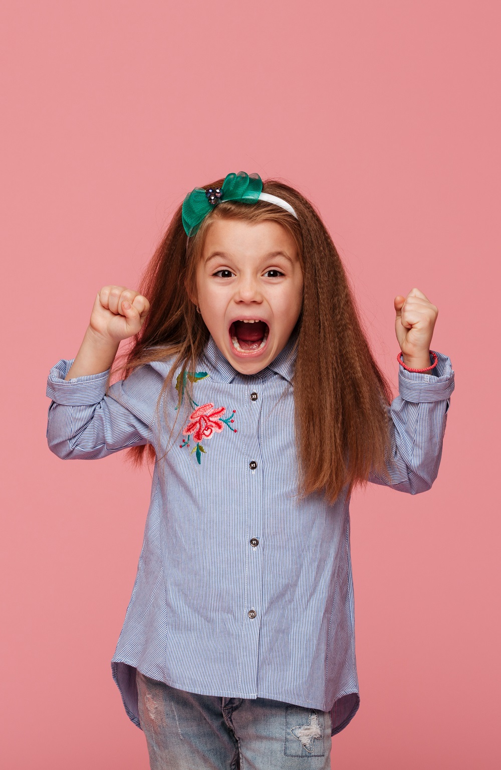 beautiful-female-kid-hair-hoop-fashion-clothes-clenching-fists-shouting-with-happiness-admiration