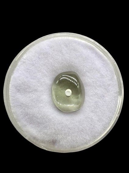 Moldavite bead with a drilled hole