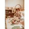 PlayandGo EEVAA treehouse puzzlemat child is playing with dolls on the mat with treehouse print in kidsroom