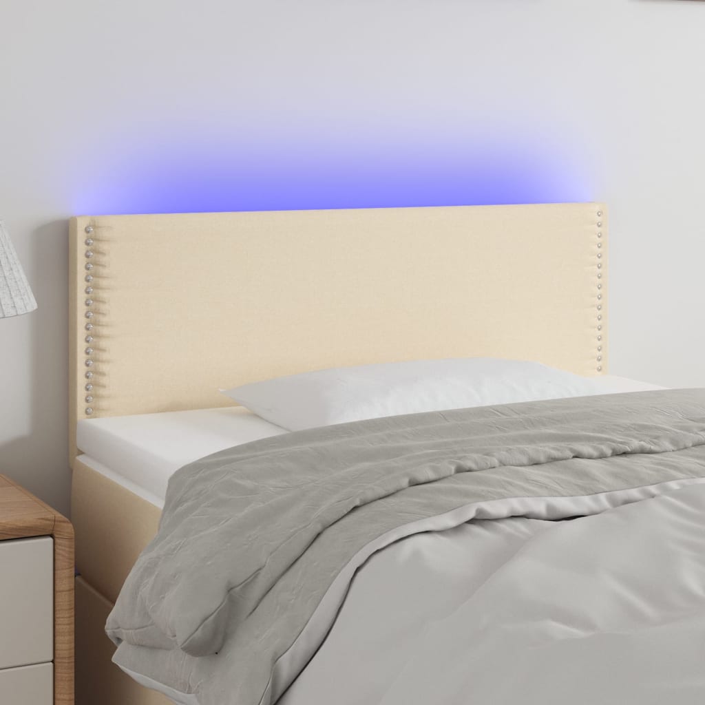 Čelo postele s LED krémové 90x5x78/88 cm textil