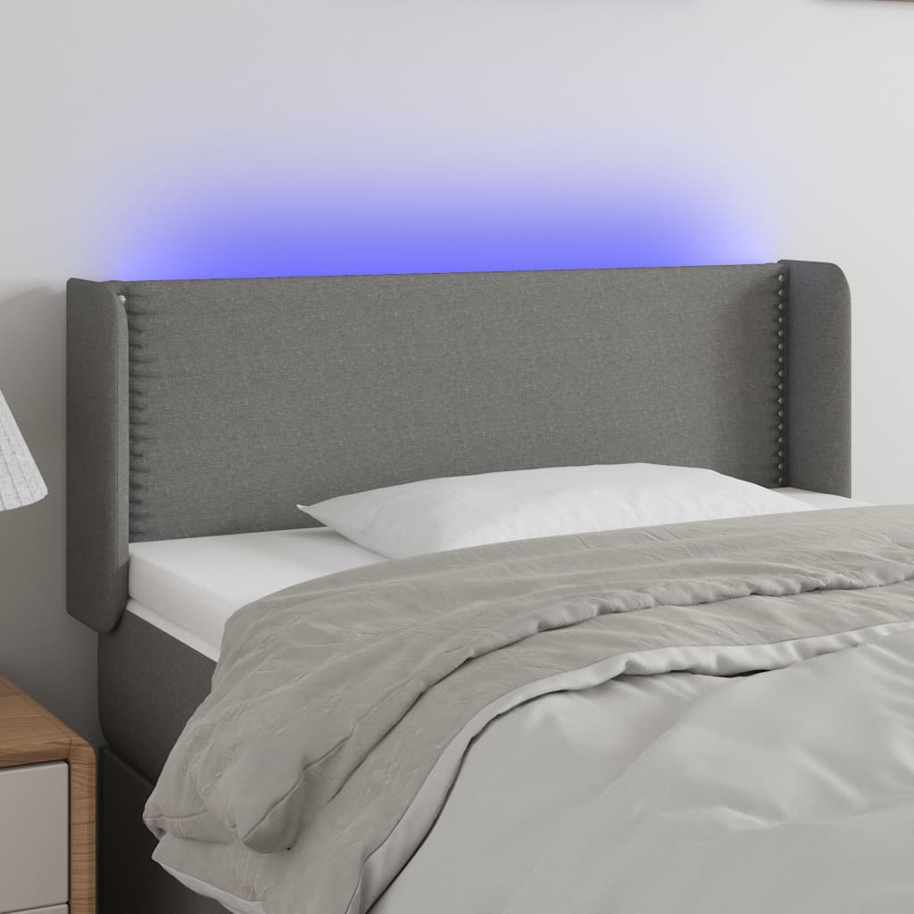 Čelo postele s LED tmavě šedé 103 x 16 x 78/88 cm textil