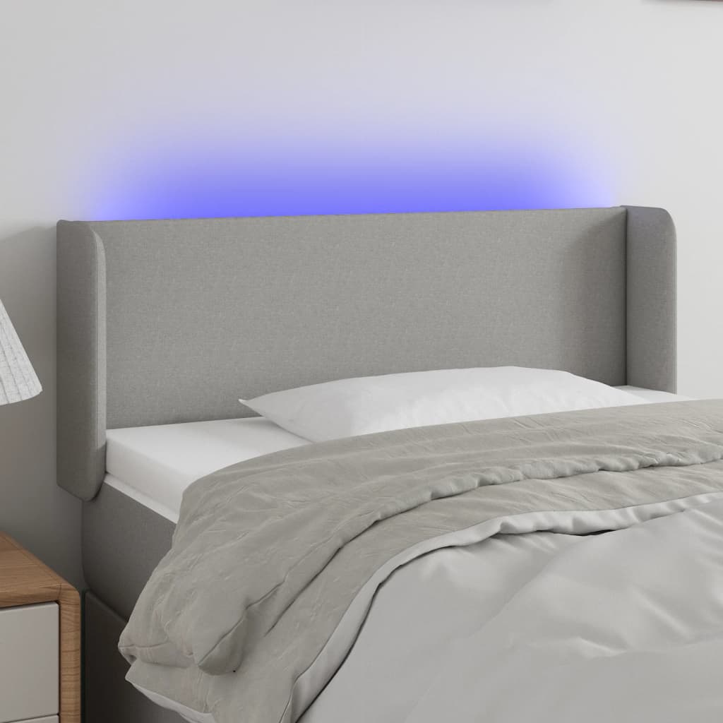 Čelo postele s LED světle šedé 83 x 16 x 78/88 cm textil