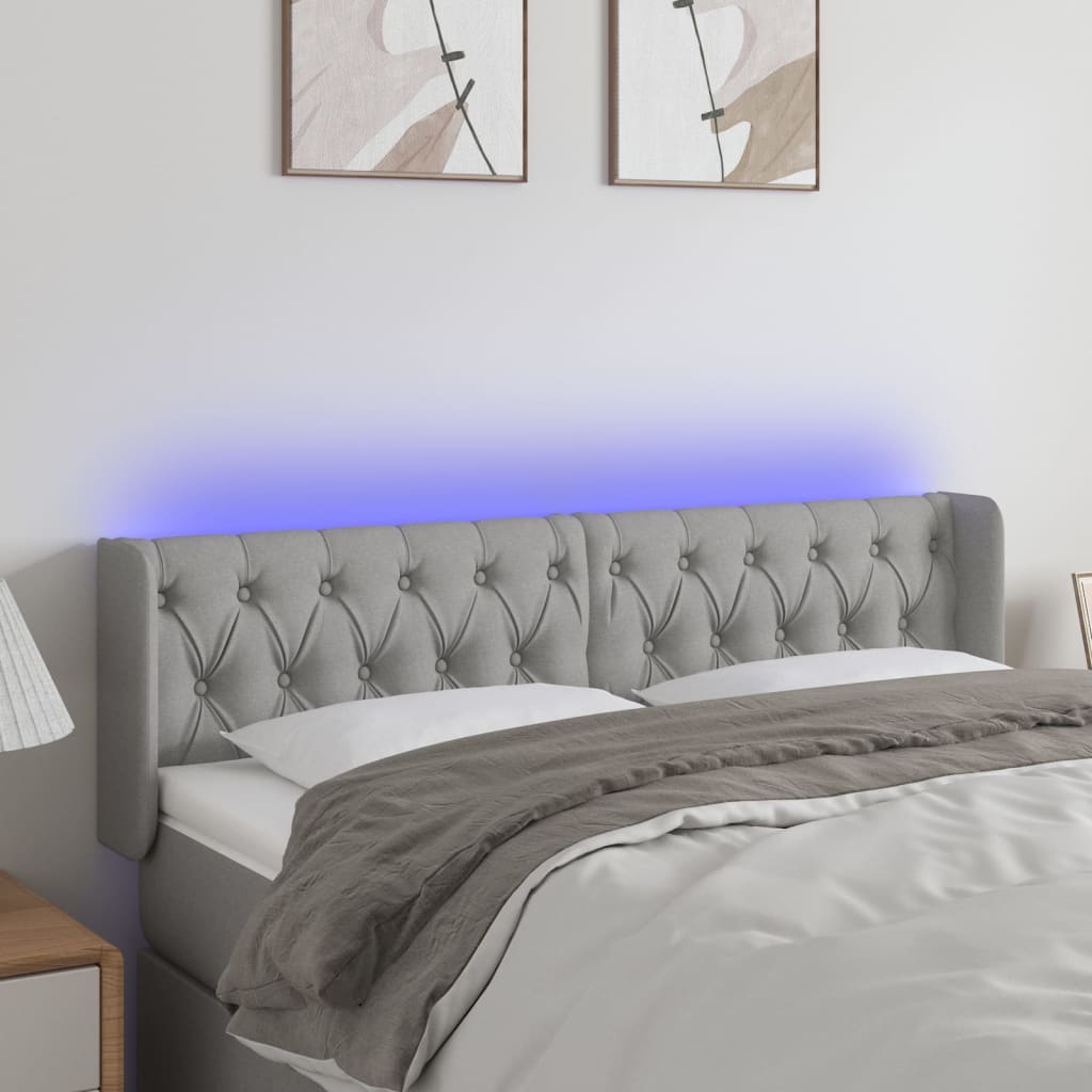 Čelo postele s LED světle šedé 163 x 16 x 78/88 cm textil