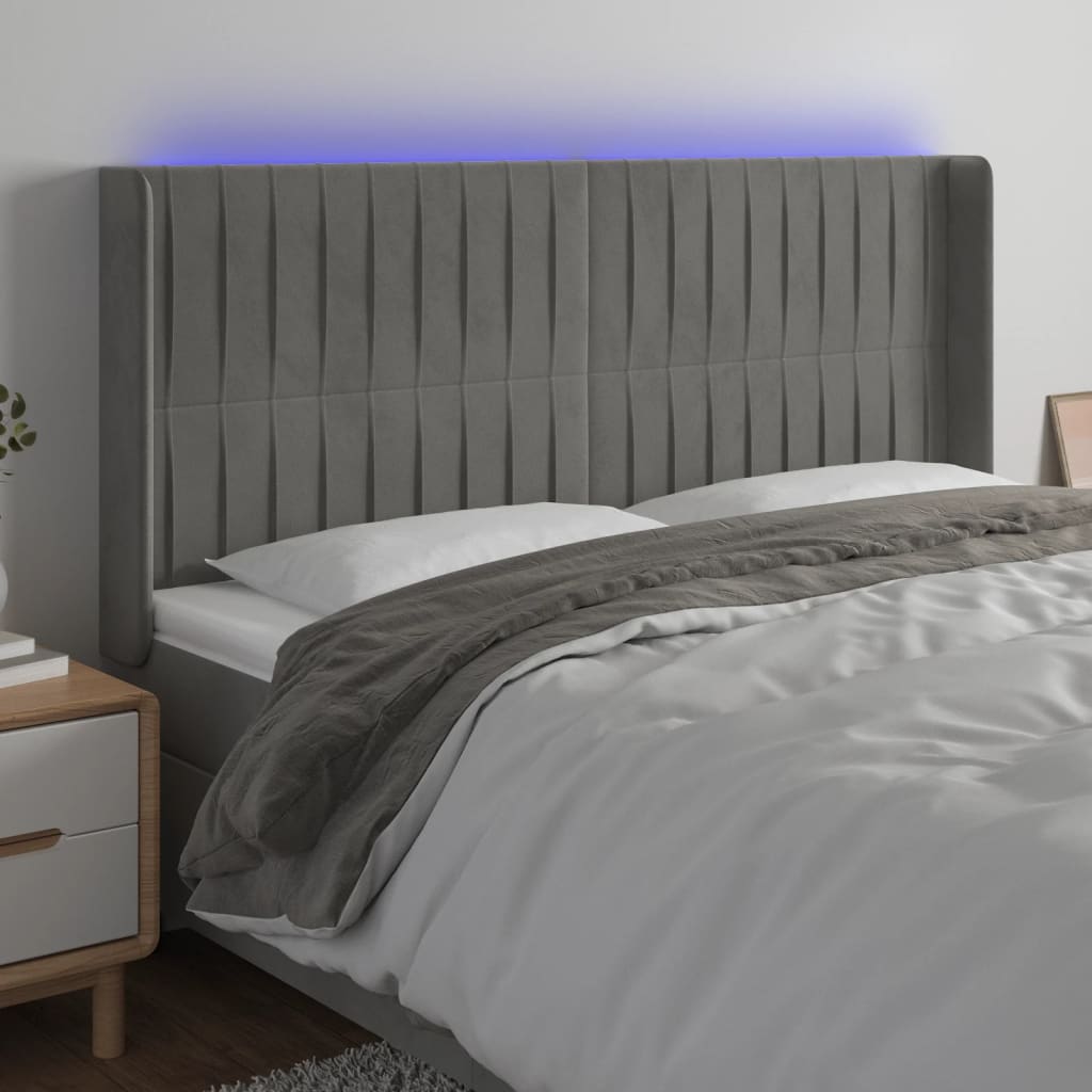 Čelo postele s LED světle šedé 163 x 16 x 118/128 cm samet