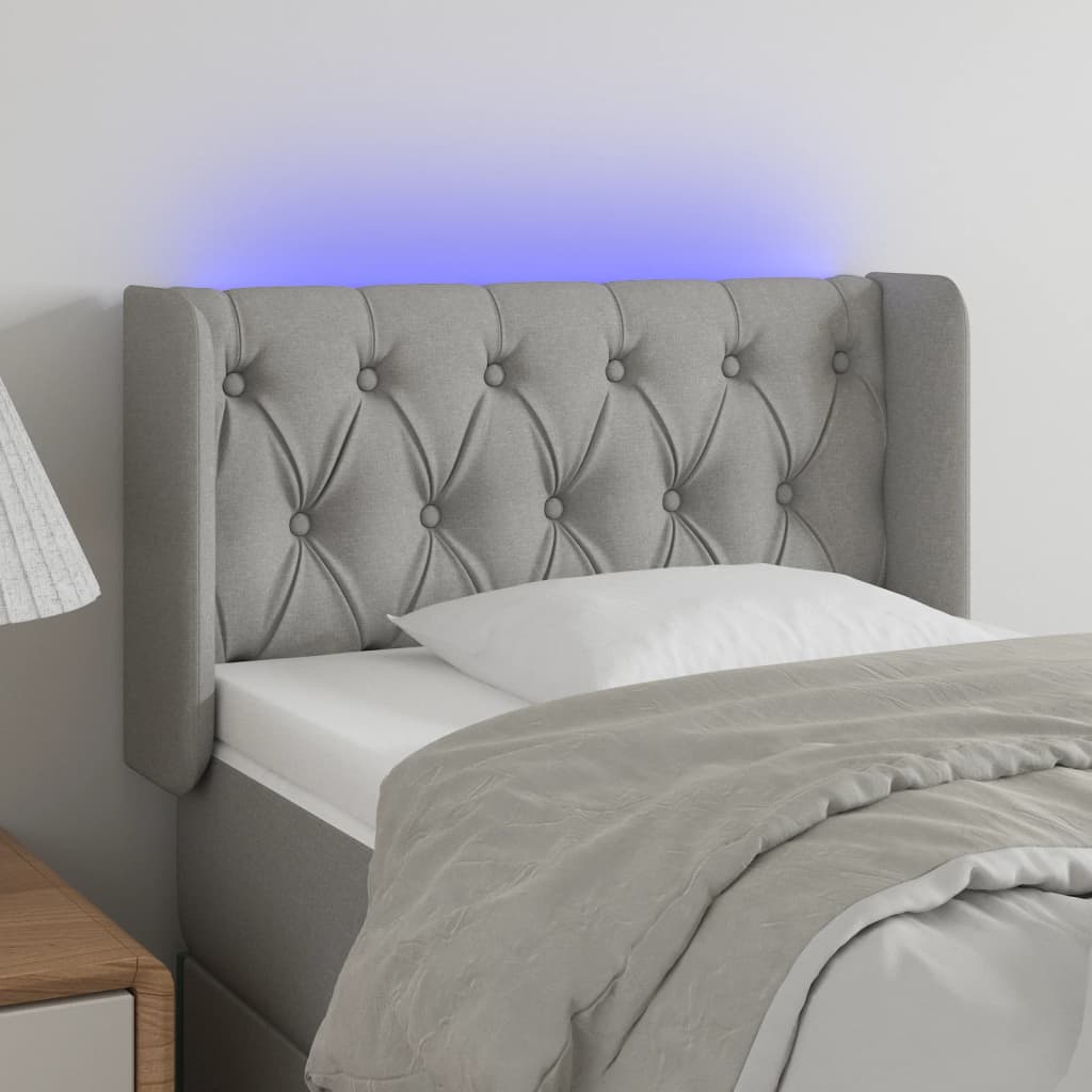Čelo postele s LED světle šedé 83 x 16 x 78/88 cm textil