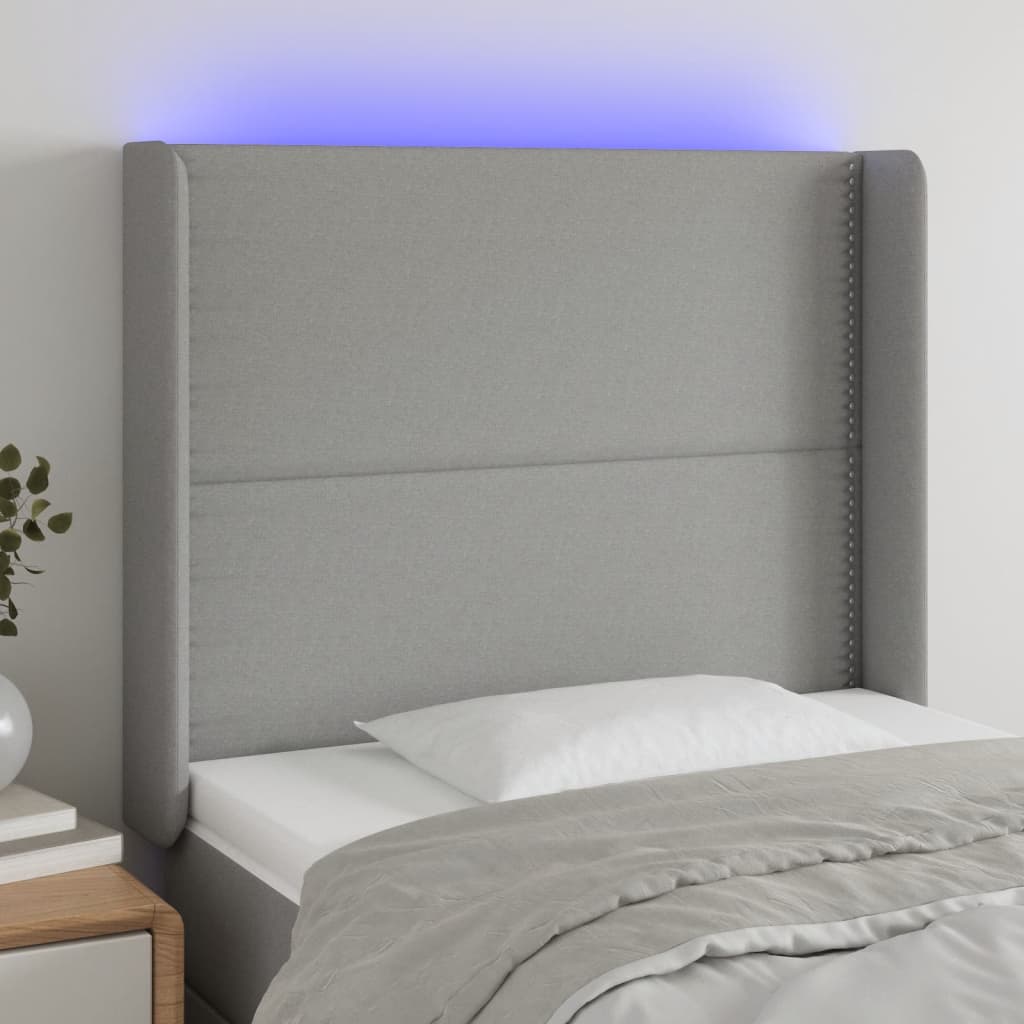 Čelo postele s LED světle šedé 83 x 16 x 118/128 cm textil