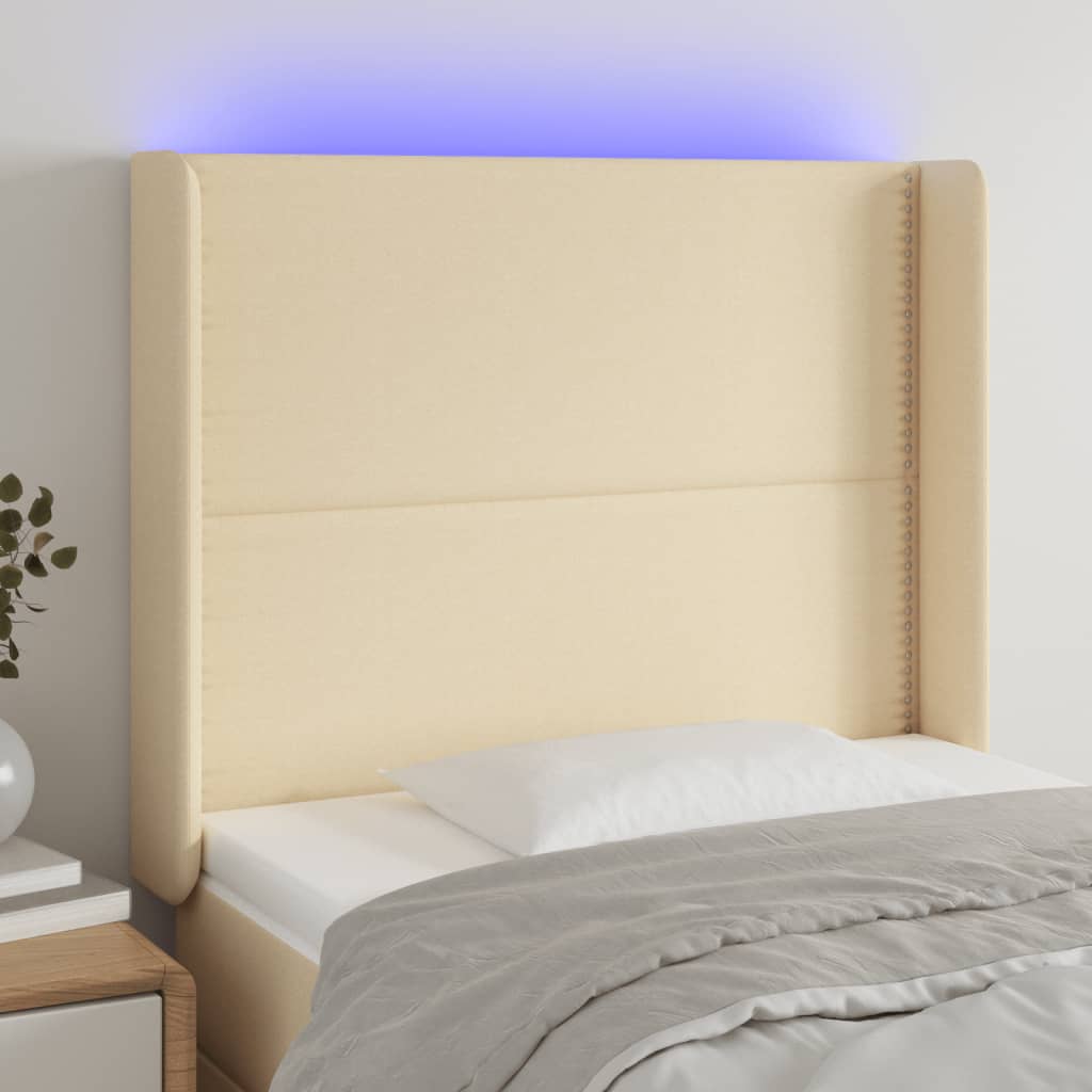 Čelo postele s LED krémové 83 x 16 x 118/128 cm textil