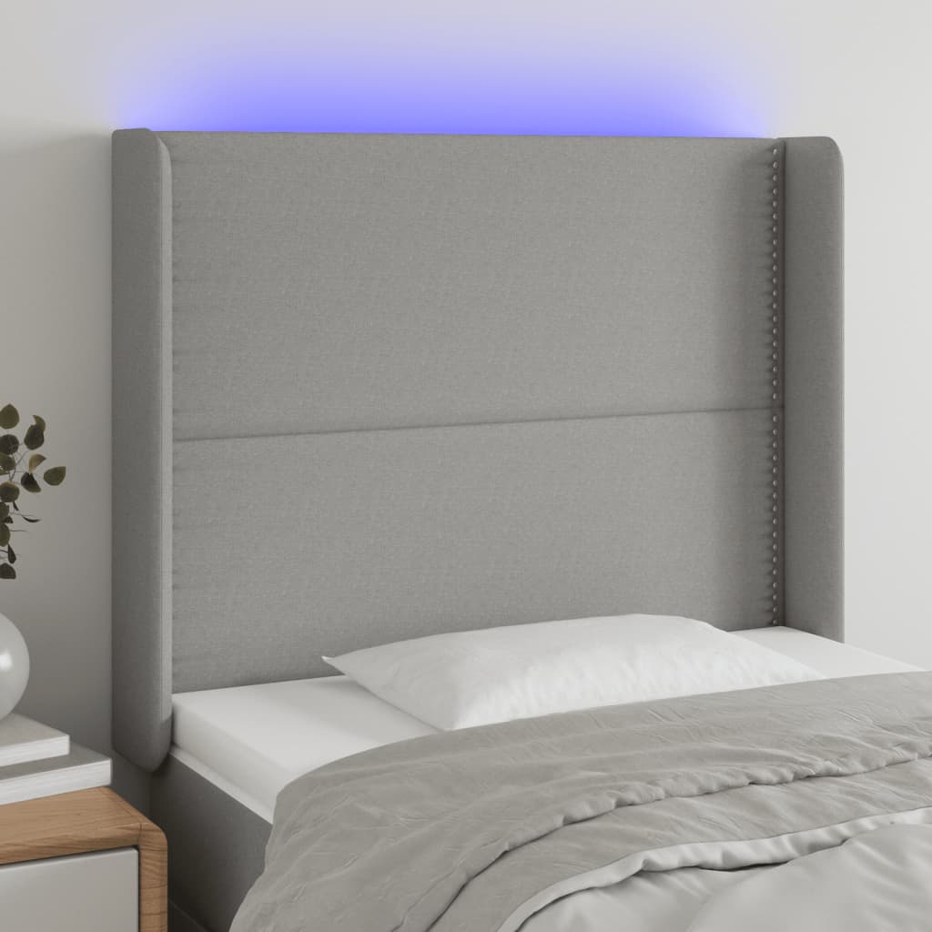 Čelo postele s LED světle šedé 93x16x118/128 cm textil