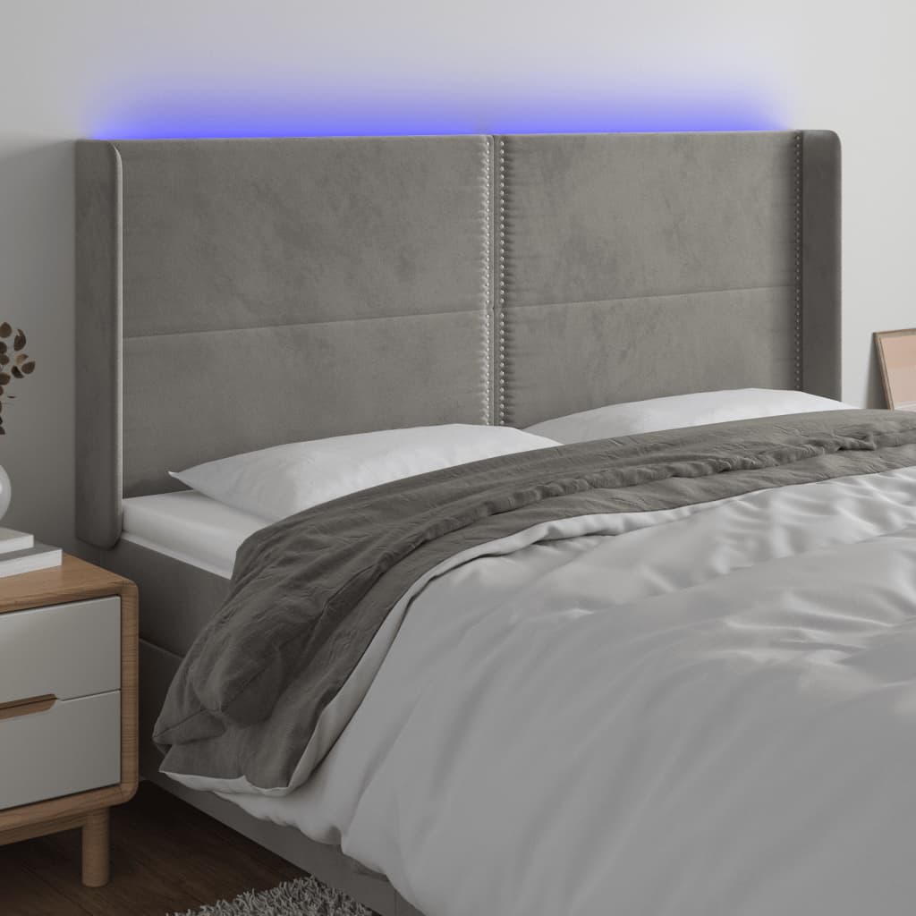 Čelo postele s LED světle šedé 163 x 16 x 118/128 cm samet