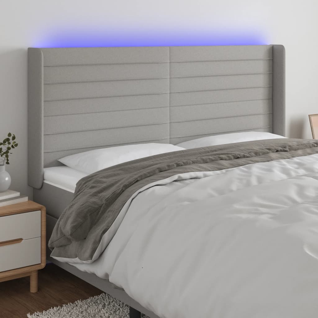 Čelo postele s LED světle šedé 203x16x118/128 cm textil
