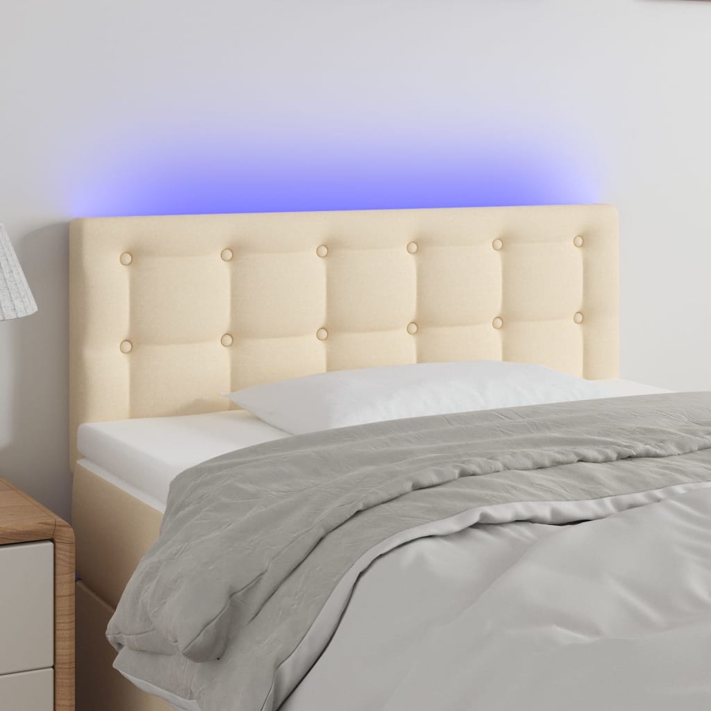 Čelo postele s LED krémové 100x5x78/88 cm textil