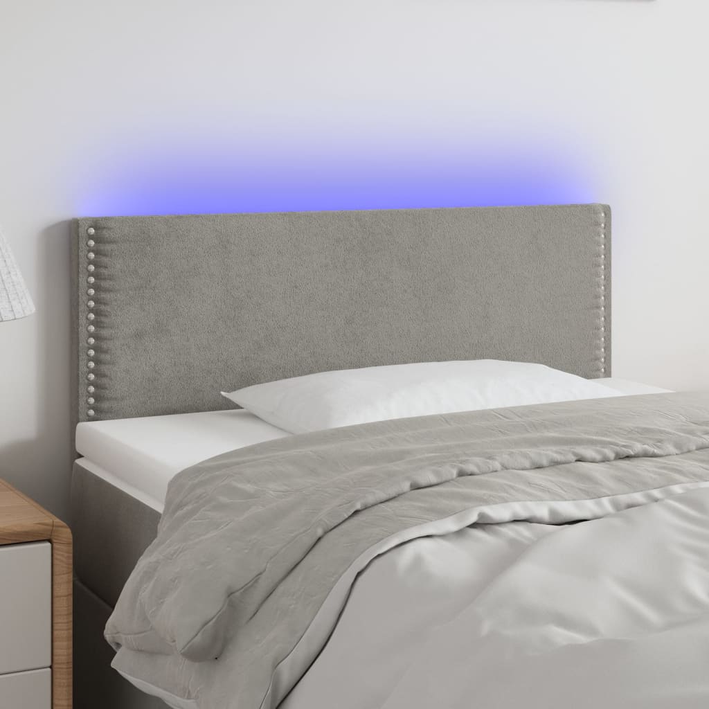 Čelo postele s LED světle šedé 90x5x78/88 cm samet