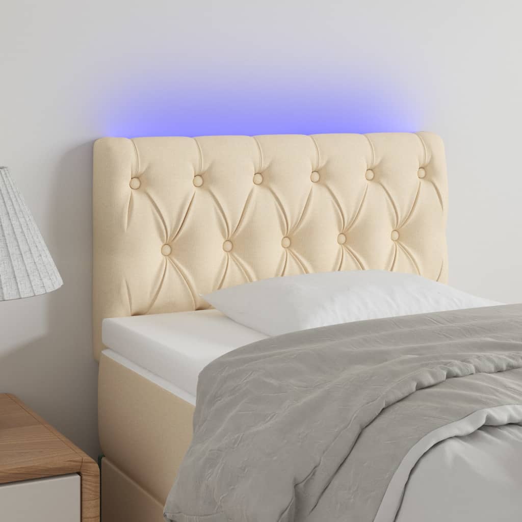 Čelo postele s LED krémové 80 x 7 x 78/88 cm textil