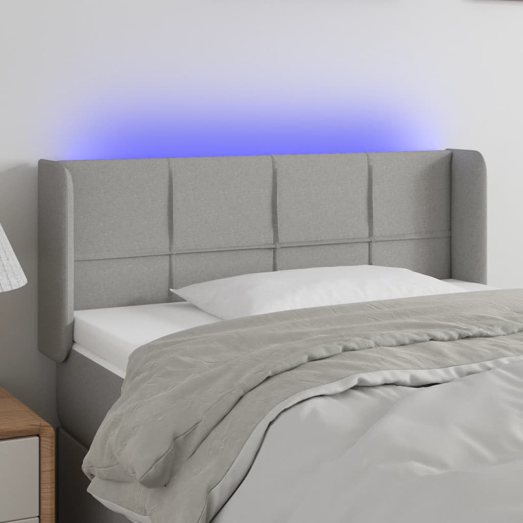 Čelo postele s LED světle šedé 103 x 16 x 78/88 cm textil