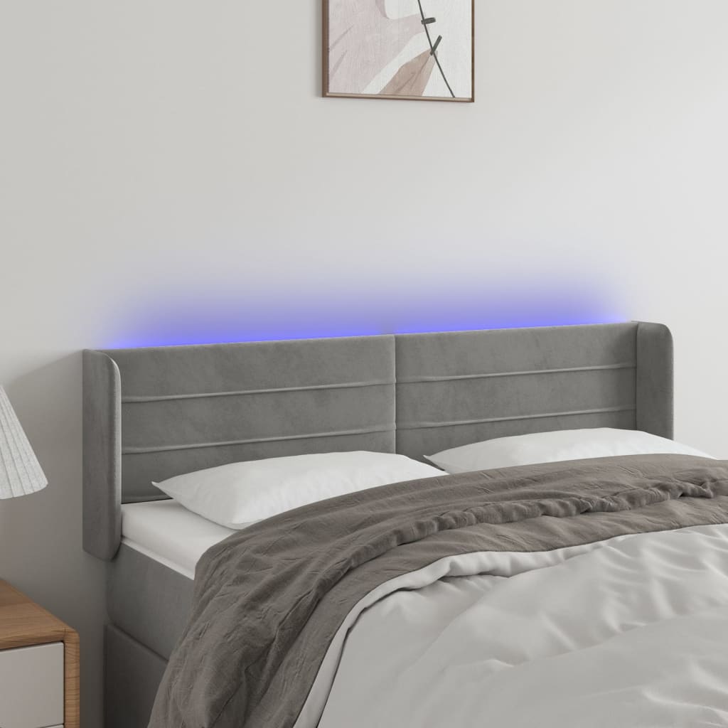 Čelo postele s LED světle šedé 147 x 16 x 78/88 cm samet