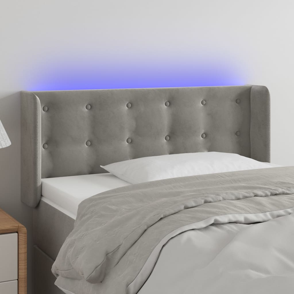 Čelo postele s LED světle šedé 103 x 16 x 78/88 cm samet