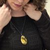 Amber pendant on a glass bead necklace