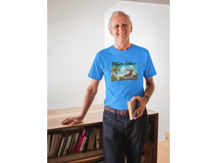 smiling man wearing a tshirt mockup holding a book in his house a20506(4)