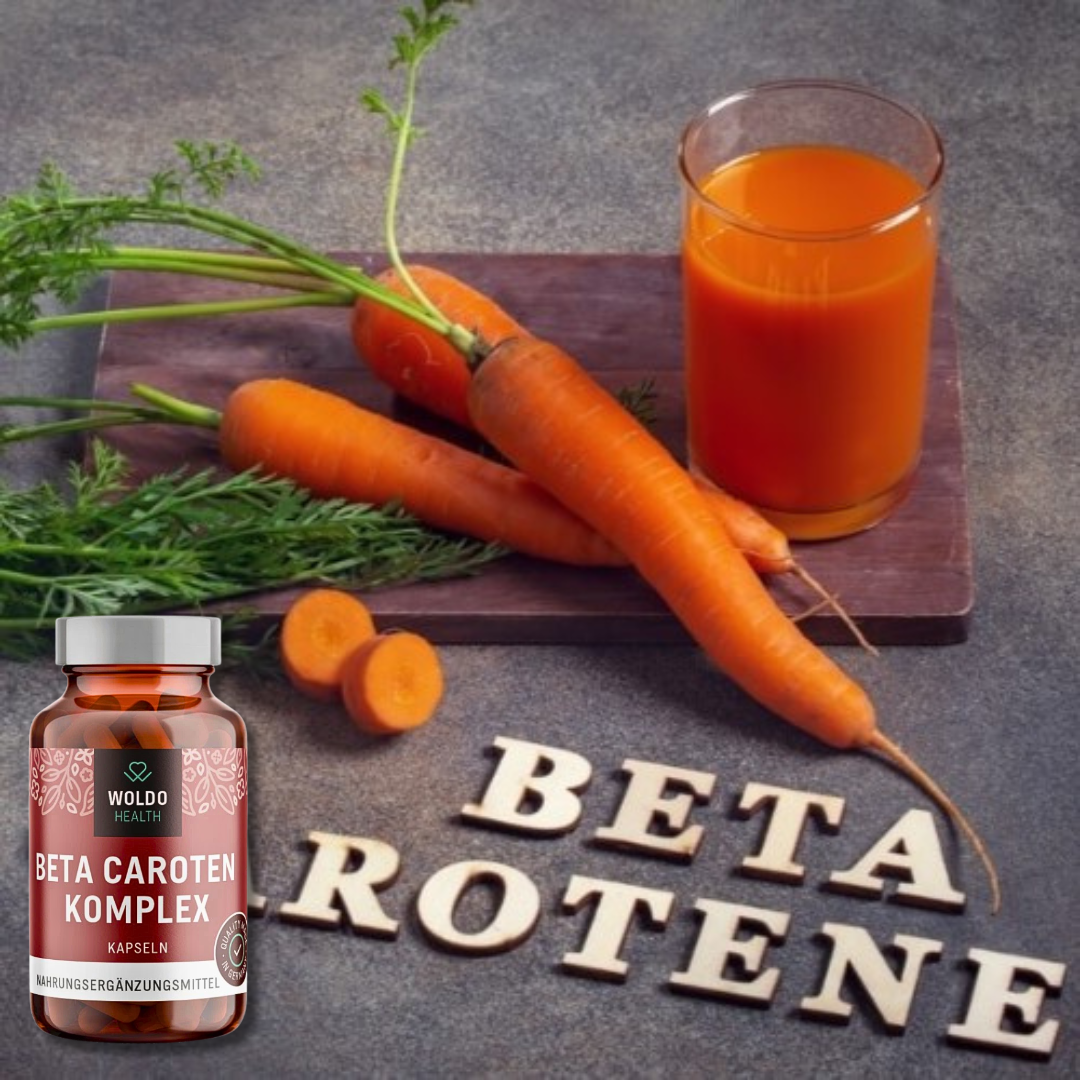 Beta carotene supplement bottle with fresh carrots, carrot juice, and the word ‘beta carotene’ displayed on a table