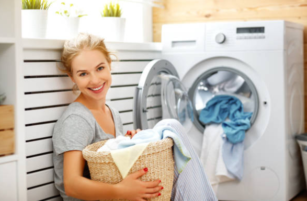 A woman sorts laundry before washing