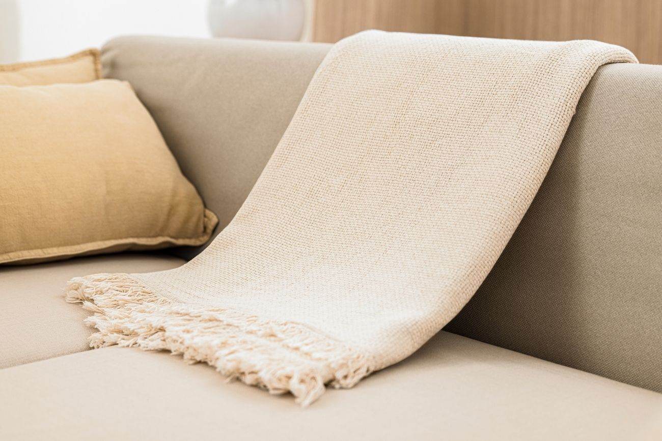 beige blanket on the sofa