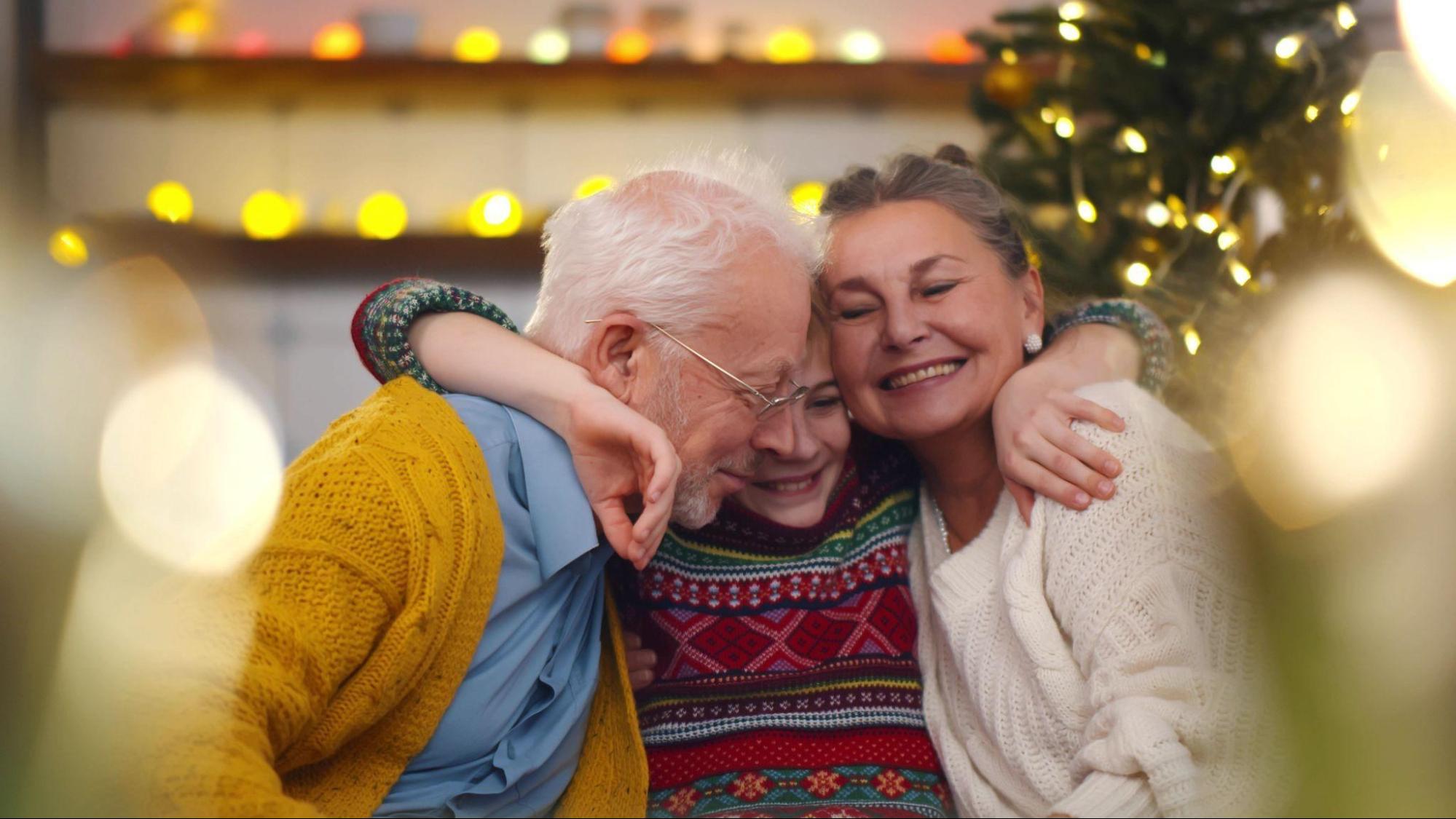 family hug by the Christmas tree