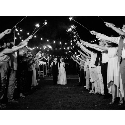 sparklers wedding newlyweds hands joyful guests(1)