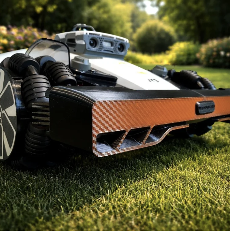 Robotická sekačka seká podél kačírkového záhonu po nastavení hranic