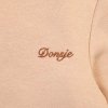 Dívčí rolák v pudrově růžové barvě od Donsje - detail loga značky