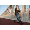 F2 II Lifestyle picture girl standing with eKickScooter bridge