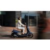 Segway eScooter E125S Lifestyle Girl riding in motion side view 2140x1428 72 1