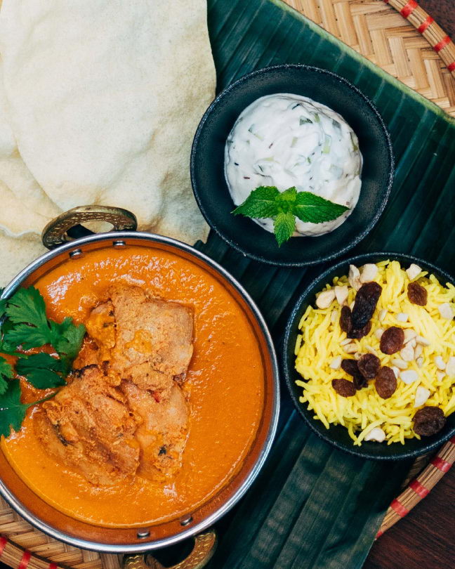 Indian Specials Week dish – butter chicken with basmati rice with saffron, raisins and
                cashews, and yoghurt raita