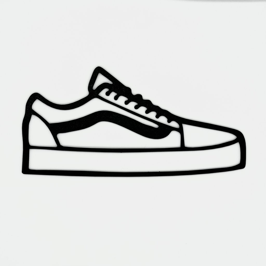 Vans Old Skool silhouette wall art with side stripe in a monochrome finish mounted above shelves