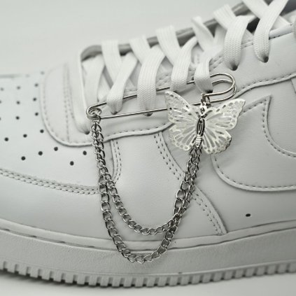 Close-up of butterfly sneaker chain on laces — adjustable metal chain with butterfly charm attached to eyelets; compatible with low-top sneakers.