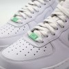 Green AF1 pastel metal lace tag adding a soft accent to white AF1 laces