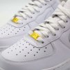 Gold AF1 special metal lace tag giving a luxe touch to the lacing